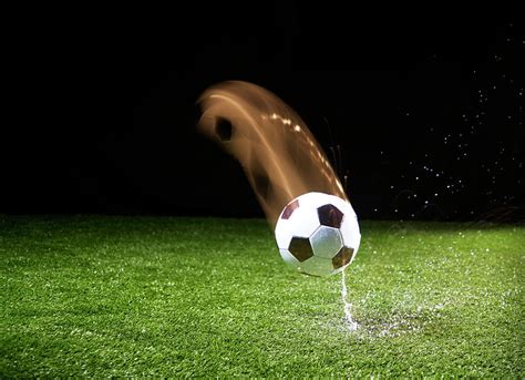 Soccer Ball Falling On Grass by Yamada Taro