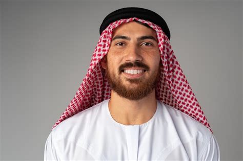 Premium Photo | Portrait of smiling young Arab man on gray background