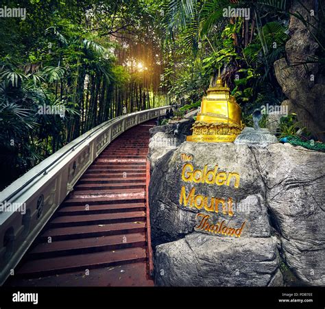 Golden Stupa statue in the tropical jungle near the stairs in Wat Saket ...