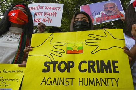 Protesters hold placards during a demonstration in New Delhi on March 3 ...