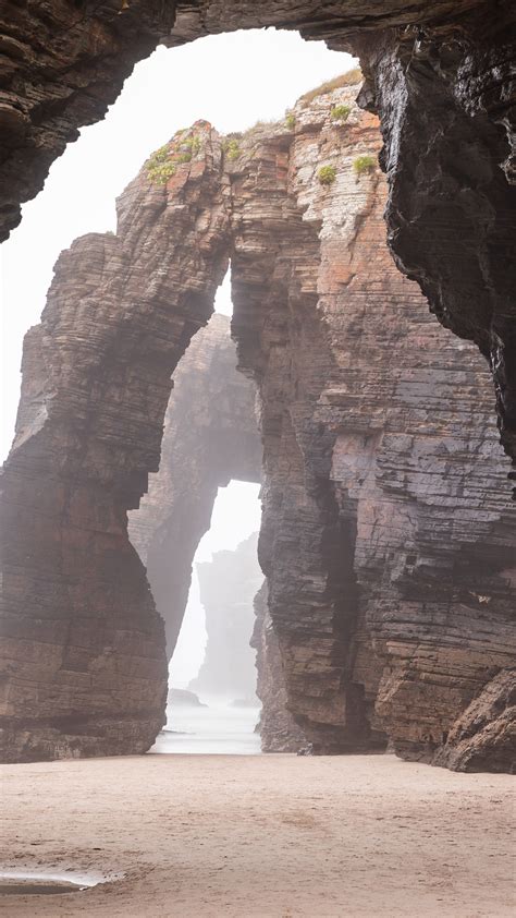 Natural rock arches on Cathedrals beach in low tide, Praia As Catedrais, Ribadeo, Spain ...