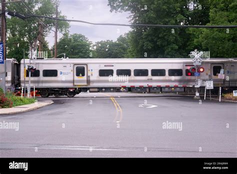 A Metro North train leaves the Katonah station, crossing Jay St then heading south to White ...