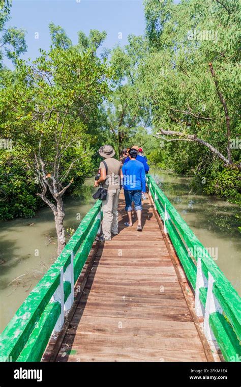 HIRON POINT, BANGLADESH - NOVEMBER 14, 2016: Tourists on a boardwalk at Hiron Point in ...