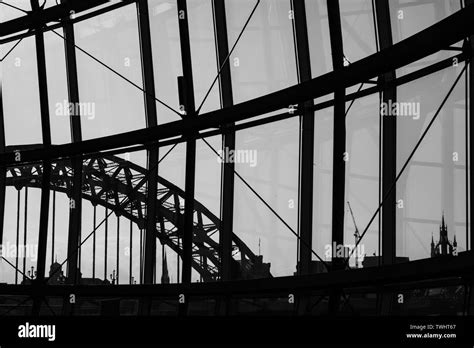 Silhouette view of Newcastle city Skyline through Sage Gateshead windows with Tyne Bridge and ...