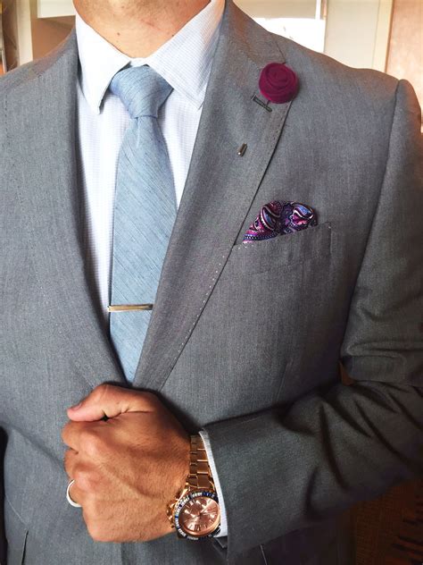 Slate grey suit, white shirt, sky blue tie with tie bar, plum color ...