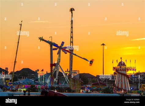 Funfair against a sunset. Fairground rides at Nottingham Goose Fair ...