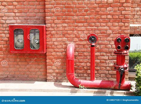 Fire Hydrant,hose And Pipes Inserted On Brick Wall Stock Photo - Image ...