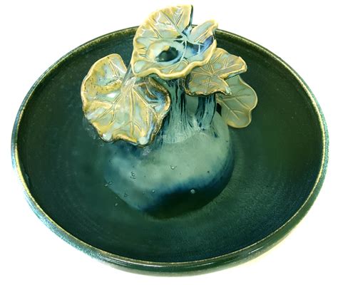 A sculpture fountain in a variety of glazes with a sculpted sea blossom