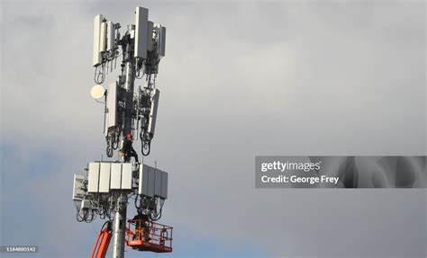 Workers rebuild a cellular tower with 5G equipment for the Verizon ...