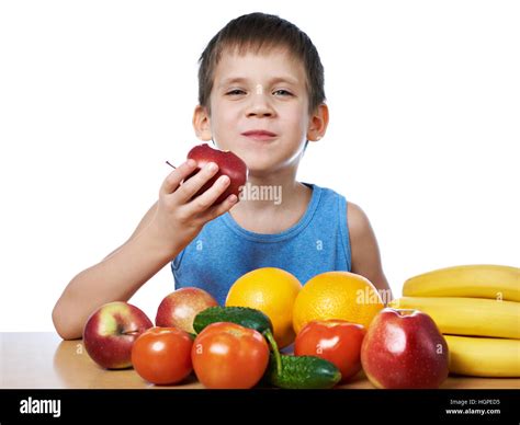 Happy healthy boy eating apple with fruits and vegetables isolated white Stock Photo - Alamy