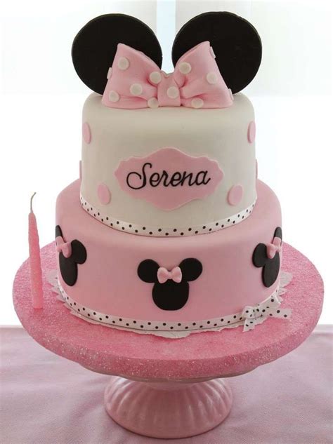 a pink and white cake with minnie mouse ears