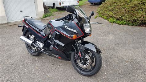 a black motorcycle parked on top of a parking lot