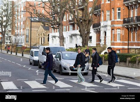 Tourists crossing the Famous Abbey Road Zebra Crossing on Abbey Road London UK Stock Photo - Alamy