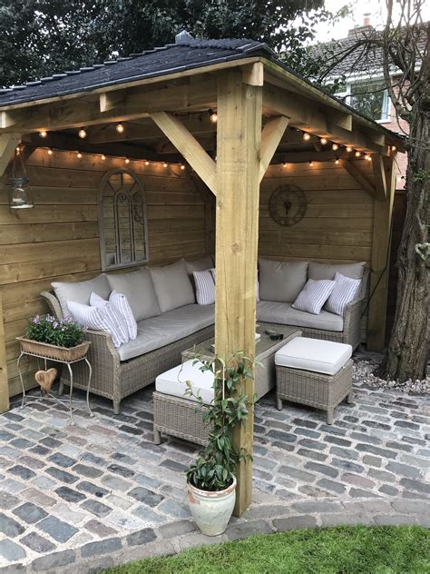 Homemade wooden gazebo, cobbles, garden lights, outdoor sofa, outdoor seating, alfresco lounging ...