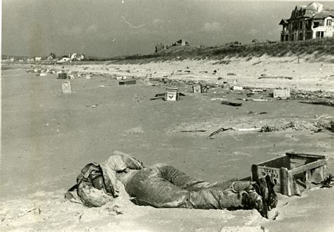 Dead British soldier washed up on littered Normandy beach, France, 1944 ...