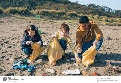 Young volunteers cleaning the beach - a Royalty Free Stock Photo from ...