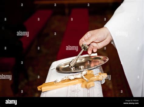 Priest blessing wedding rings during the ceremony Stock Photo - Alamy