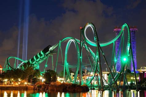 the roller coaster is lit up at night