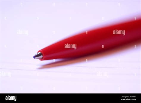 Red biro pen on paper close up Stock Photo - Alamy