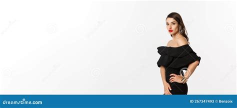 Profile View of Woman with Red Lips and Makeup, Wearing Black Dress, Posing Over White ...
