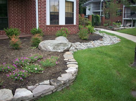 via Mainstreet Landscape. Stone raised bed, connected with dry creek bed. Love the idea ...