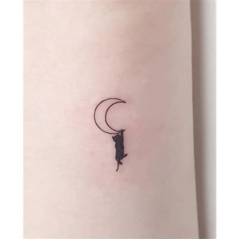 Minimalistic style black cat and moon tattoo done on