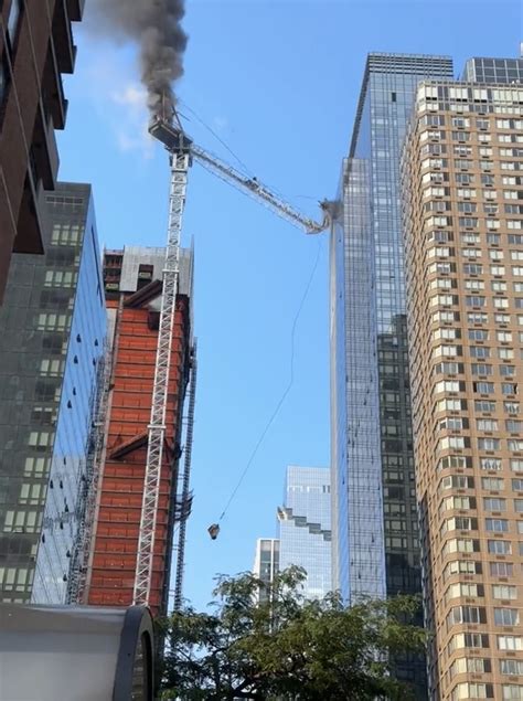 Shocking moment burning NYC crane collapses onto street: video