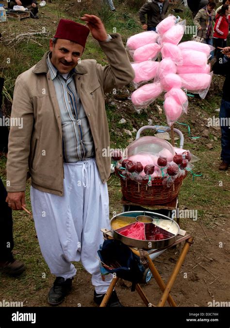 Turkish man in fez hat selling candy during Selcuk-Efes Camel Wrestling ...