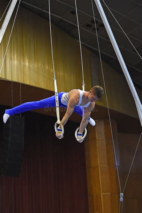 Male Gymnast Performing on Stationary Gymnastic Rings Editorial Stock Image - Image of ...