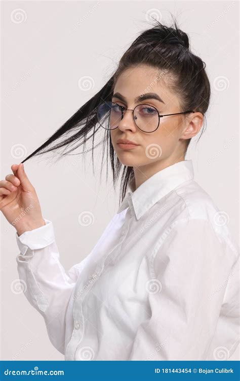 Beautiful Caucasian Hipster Girl with Black Hair and Glasses is Posing in Studio on Isolated ...