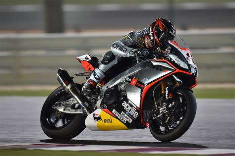 man in racing suit and helmet riding silver and orange sports motorcycle free image | Peakpx