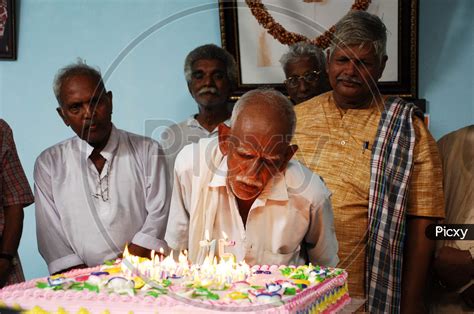 Image of Old Man Cutting Cake In an Old Age Home-LV119067-Picxy