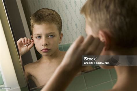 Boy Cleaning Ears In Bathroom Stock Photo - Download Image Now - Bathroom, Blond Hair, Boys - iStock