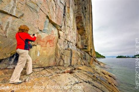 Woman on Rock Ledge along the Agawa Rock Pictographs Trail in Lake ...