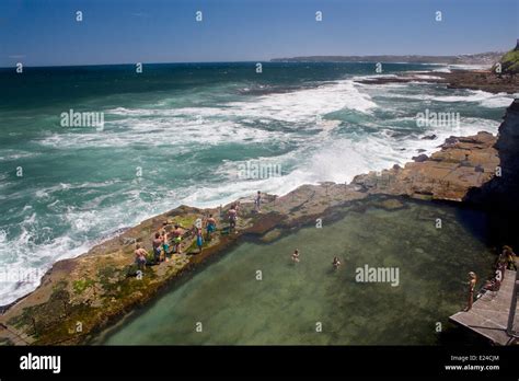 Bogey Hole Rock pool at base of cliff next to sea Pacific Ocean Newcastle New South Wales NSW ...