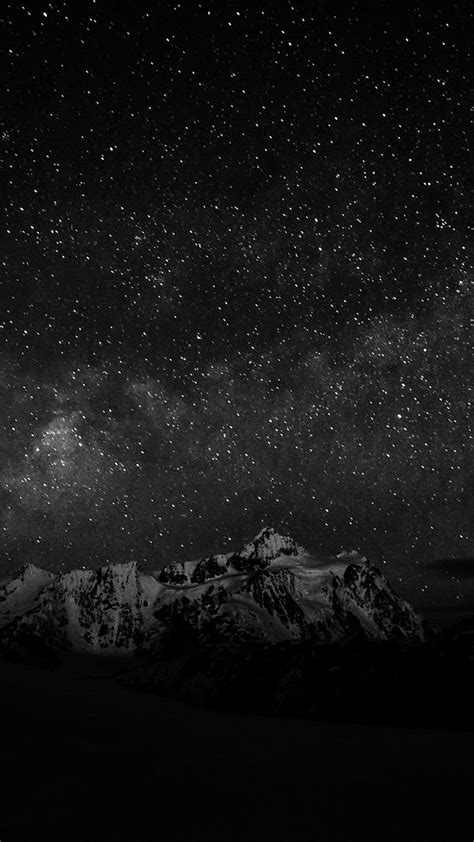 the night sky is filled with stars above mountains and snow - capped mountain tops in black and ...