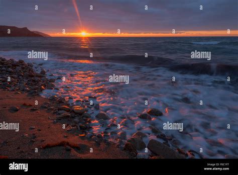 Sea beach on sunset time Stock Photo - Alamy