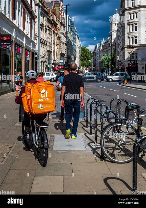 Just Eat Food Delivery Courier on a pavement in Central London. Just ...