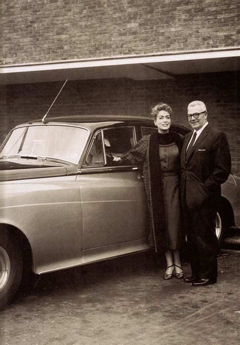 Joan Crawford and husband, Alfred Steele (CEO of Pepsi-Cola) pose next to their 1958 Roll Royce ...