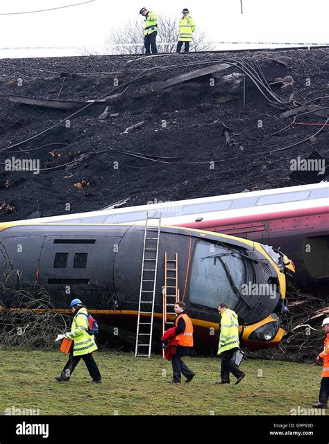 Accident investigators search the wreckage of the Virgin Pendolino ...