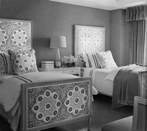 a black and white photo of two beds in a bedroom