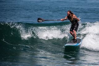 Male Stand-up Paddle (SUP) surfer with tattoos, long hair,… | Flickr