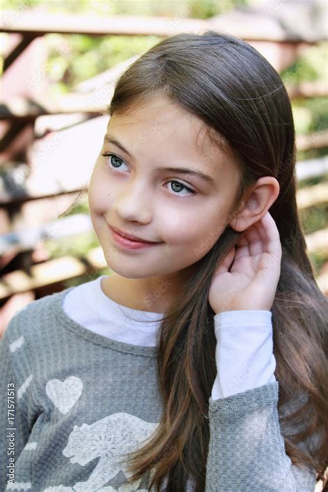 Young pre-teen girl age 10 - 13 years old with long hair. Stock Photo | Adobe Stock