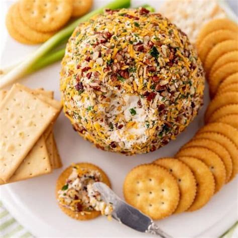 cheese ball with crackers and asparagus on a plate