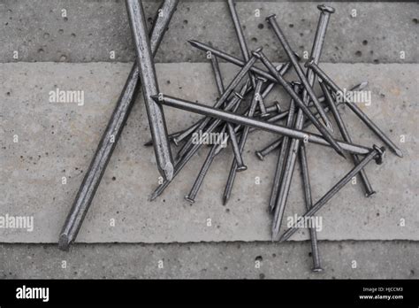 Different types of nails on a concrete background Stock Photo - Alamy