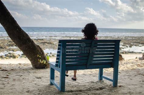 Girl Sitting Alone on a Bench Near Seashore Stock Photo - Image of ...