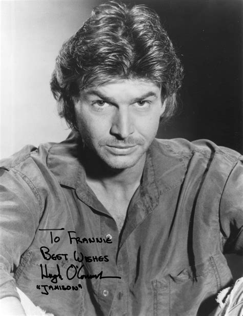 an old black and white photo of a man with his hand on his chest, looking at the camera