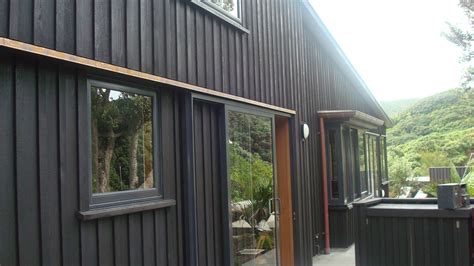 Board and Batten with resene stain-Piha | House cladding, Board and ...