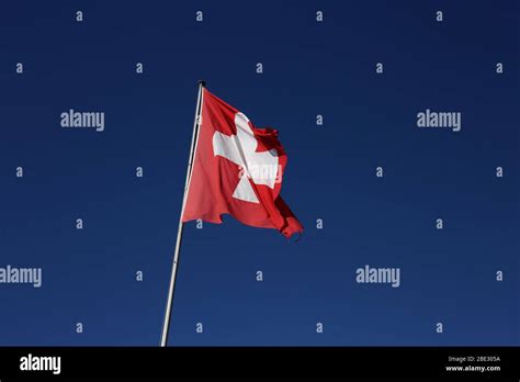 The Swiss flag photographed in Bern, Switzerland during a windy day ...