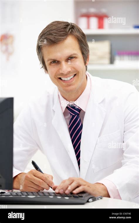 Hospital doctor at desk Stock Photo - Alamy